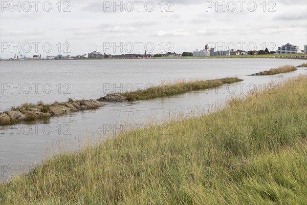 Flooded shore path at high tide on the beach of Cuxhaven