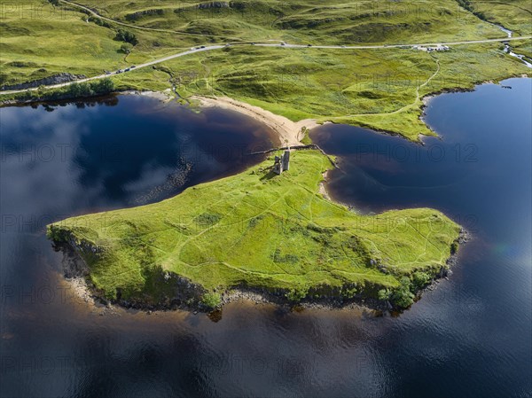 Aerial view of the freshwater loch Loch Assynt with the ruins of Ardvreck Castle on a peninsula