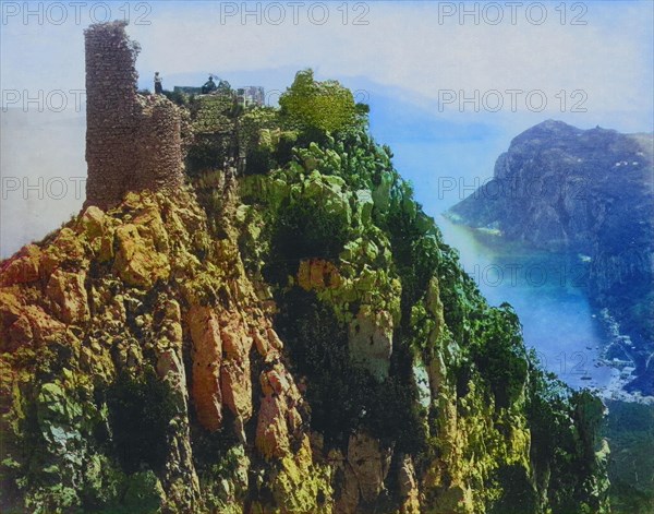 View of the ruins of Castello Barbarossa on Capri with a man and a woman on top