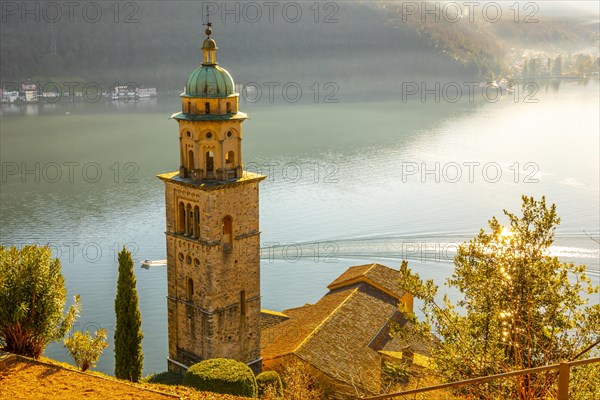 Church Tower Santa Maria del Sasso with Sunlight and Mountain on Lake Lugano in Morcote