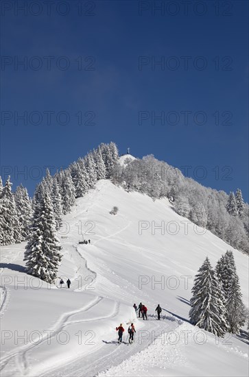 Deep snowy winter landscape with ski tourers on the way to the Zwoelferhorn