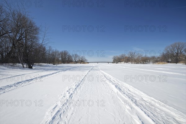 Vehicle tracks on snow covered frozen river