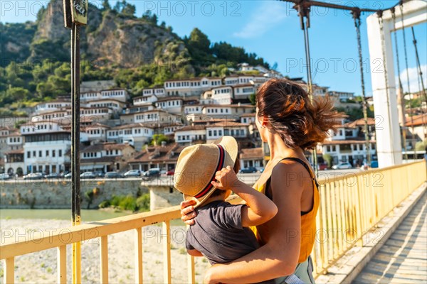 A woman with her son on the bridge in the historic city of Berat in Albania