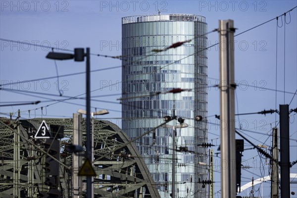 The Koelntriangle office tower with arches of the Hohenzollern Bridge and railway overhead line