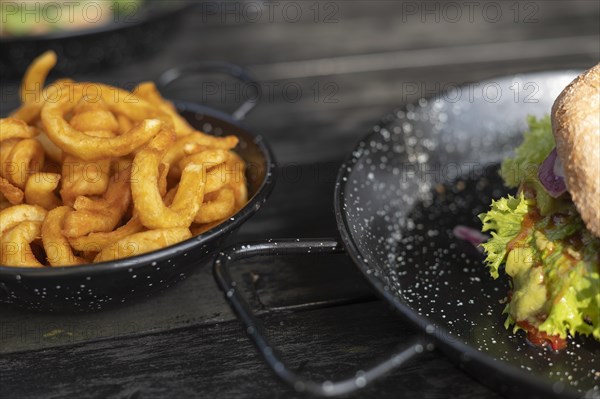 Vegan burger in cut and curly fries