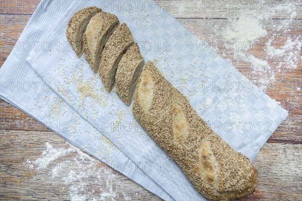 Freshly baked vegan baguette with sesame seeds