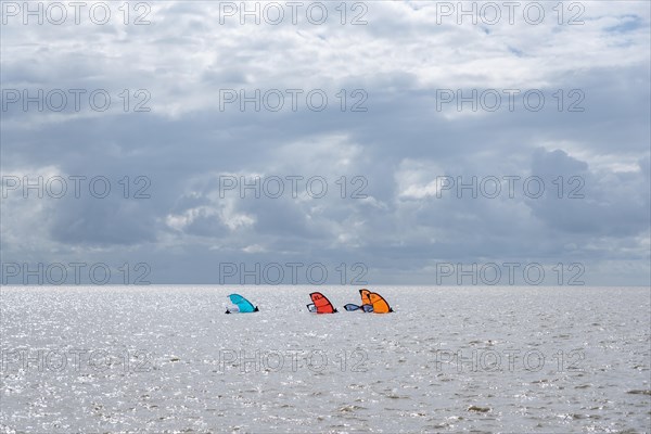 Windsurfers in front of the beach promenade