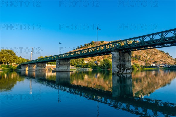 View of Rozafa Castle and the river bridge from a boat on a sightseeing excursion on Lake Shkoder in Shiroka. Albania