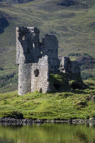 The ruins of Ardvreck Castle on a peninsula in the freshwater loch of Loch Assynt