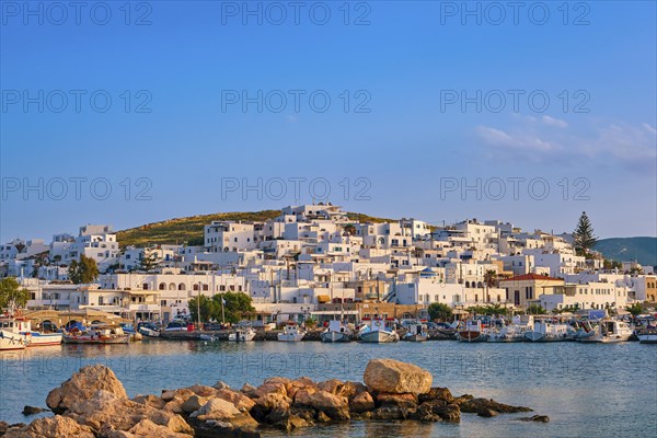 Beautiful tradition Greek fishermen village on hilltop. Colorful boats moored by jetty