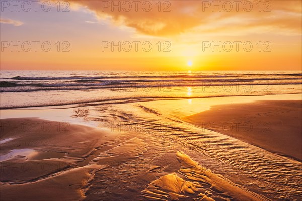 Atlantic ocean sunset with surging waves at Fonte da Telha beach