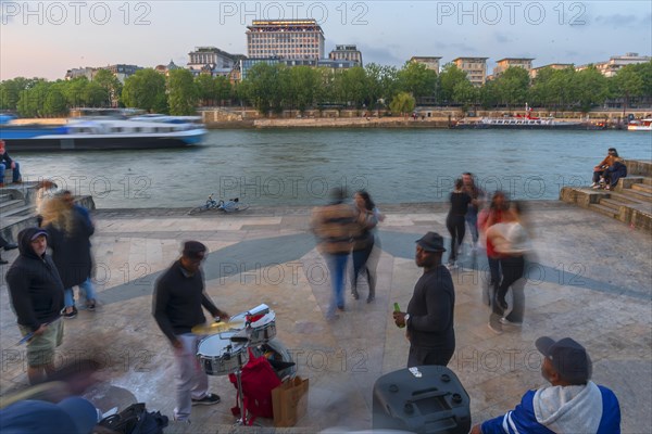 Evening dance and music of young people on the banks of the Seine