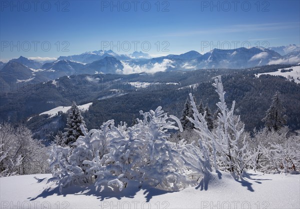 Winter landscape covered in deep snow at the summit of the Zwoelferhorn with a view of the Osterhorn group