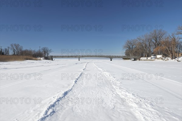 Vehicle tracks on snow covered frozen river