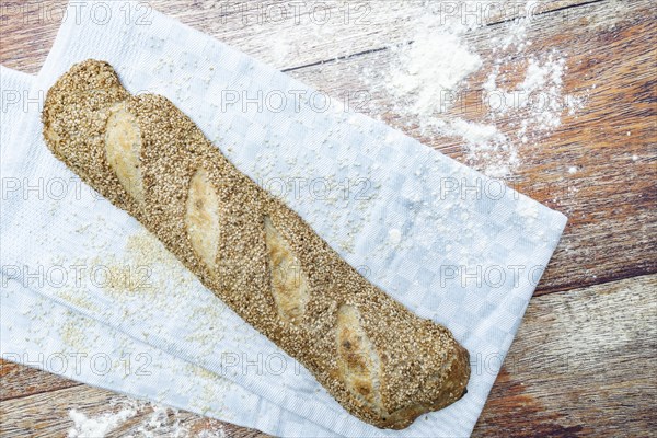 Freshly baked vegan baguette with sesame seeds