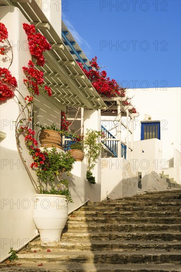 Traditional Greek island town alleyway with whitewashed walls