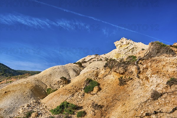 Unique natural rock formations of yellow and orange cliffs in low sunlight