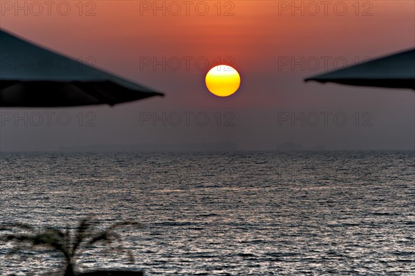 Sunset between parasols