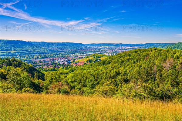 View over the city of Jena from the Galgenberg with the Kernberge in the background under blue sky and veil clouds