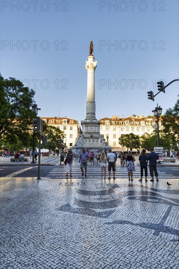 Pedestrian in front of statue of Pedro IV