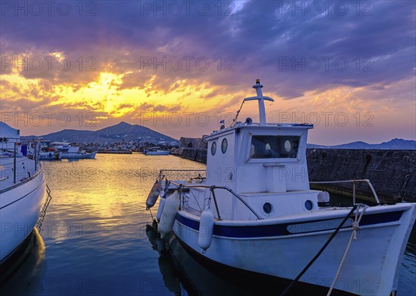 Colorful sunset over quiet Greek fishing village and its harbour