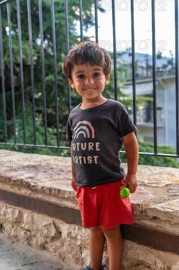 Portrait of two year old boy looking at camera enjoying summer vacation