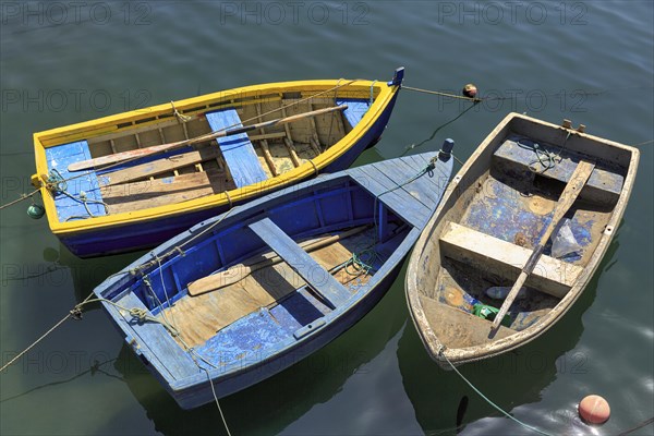 Three rowing boats side by side in the harbour