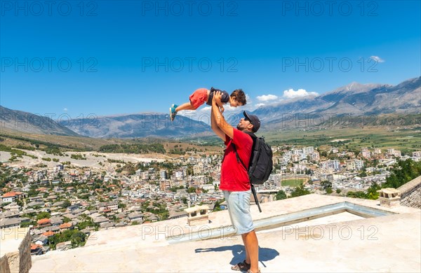 A father with his son having fun in the Ottoman Castle Fortress of Gjirokaster or Gjirokastra. Albanian