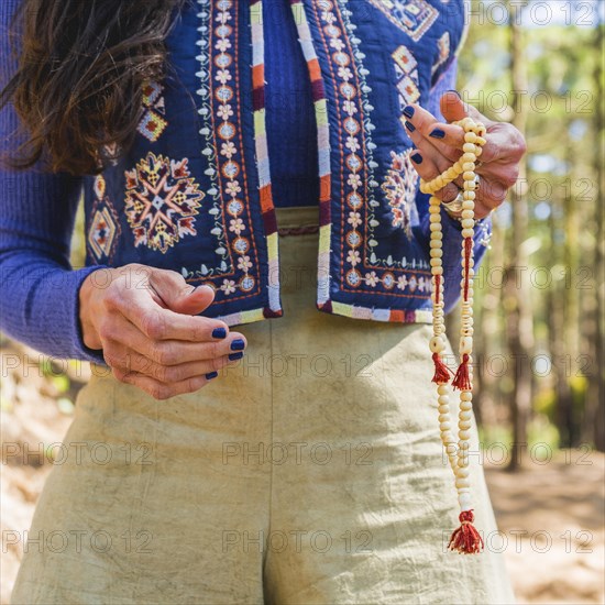 Close up of a woman holding a japa mala