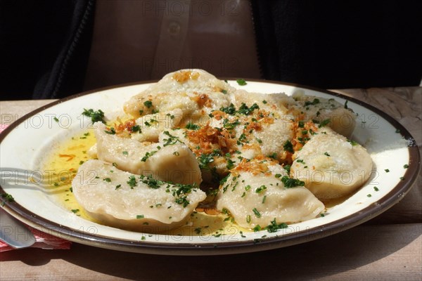 Typical Tyrolean Schlutzkrapfen or Schlipfkrapfen at a mountain hut