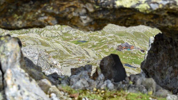 View through a rock window to the Magdeburger Huette in the Stubai Alps