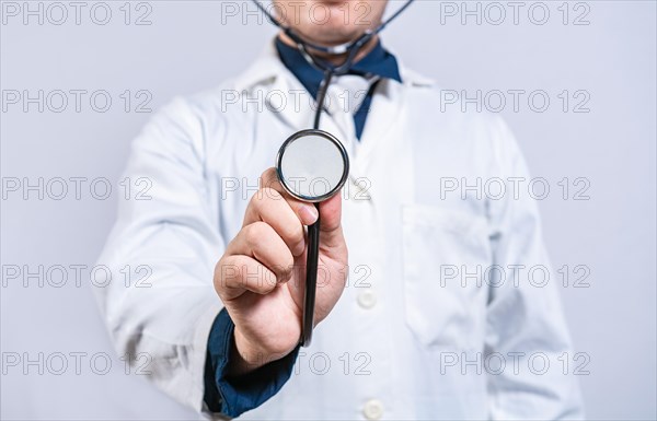 Close up of doctor showing stethoscope medical isolated. Unrecognizable doctor holding a stethoscope