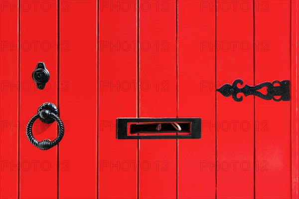 Red wooden door with fittings