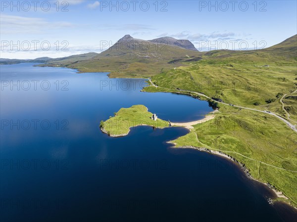 Aerial view of the freshwater loch Loch Assynt with the ruins of Ardvreck Castle on a peninsula