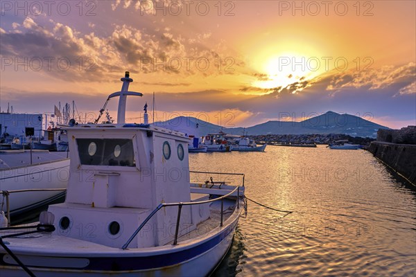 Colorful sunset over quiet Greek fishing village and its harbour