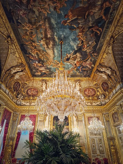 Beautiful decorated Napoleon apartments at Louvre palace. Royal family rooms with cardinal red curtains