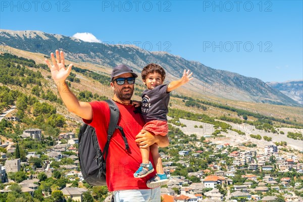 Portrait of a father with his son having fun in the Ottoman Castle Fortress of Gjirokaster or Gjirokastra. Albanian