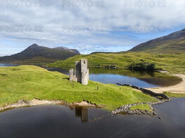 Aerial view of the freshwater loch Loch Assynt with the ruins of Ardvreck Castle on a peninsula