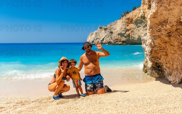 Portrait of a family having fun on Porto Katsiki beach in Lefkada island on vacation