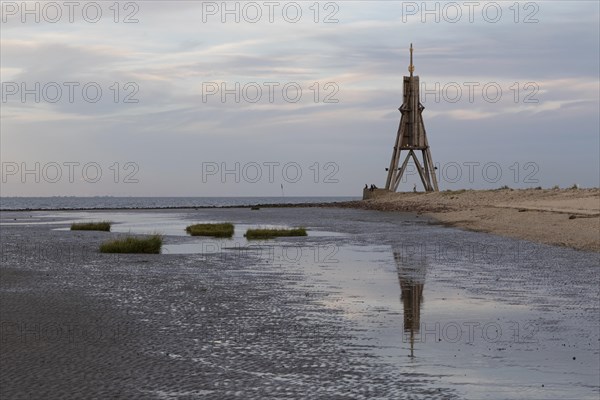 Kugelbake with water reflection in the mudflats at low tide at dusk