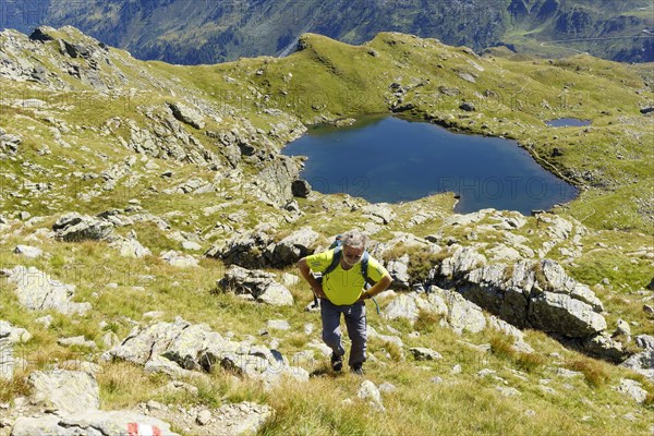 Hiker climbing the mountain Schafsiedel