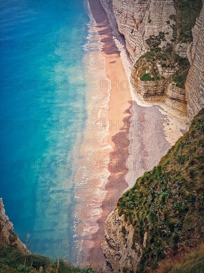 Tropical lagoon aerial view. A beach hidden behind the high cliffs and washed by the blue and clean ocean water. Summer seaside background