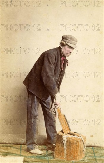 Portrait of an unknown man with a wooden block and a brush