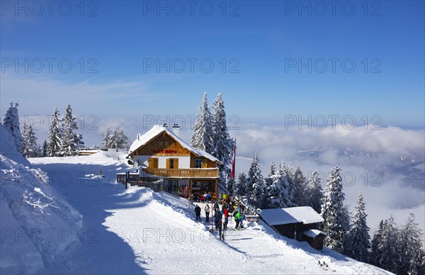 Winter landscape with ski tourers and alpine hut at Zwoelferhorn