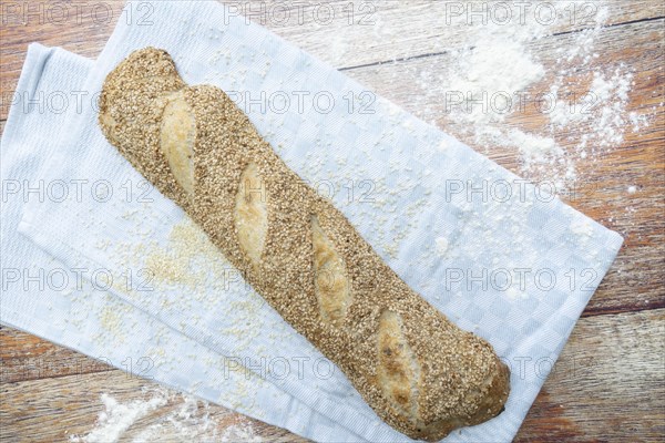 Freshly baked vegan baguette with sesame seeds