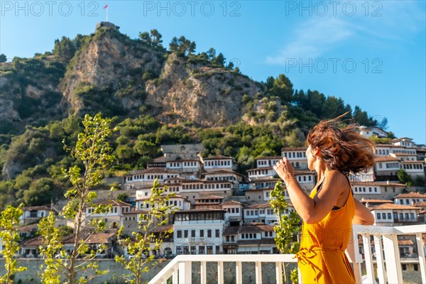 A woman looking at the historic town of Berat in Albania enjoying the holidays