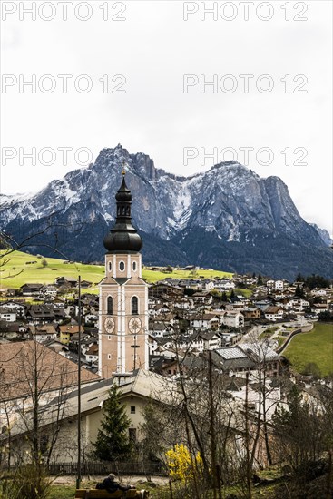 Village and snow-capped mountains