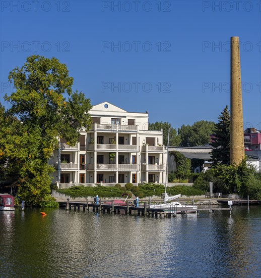 Villa next to a factory chimney