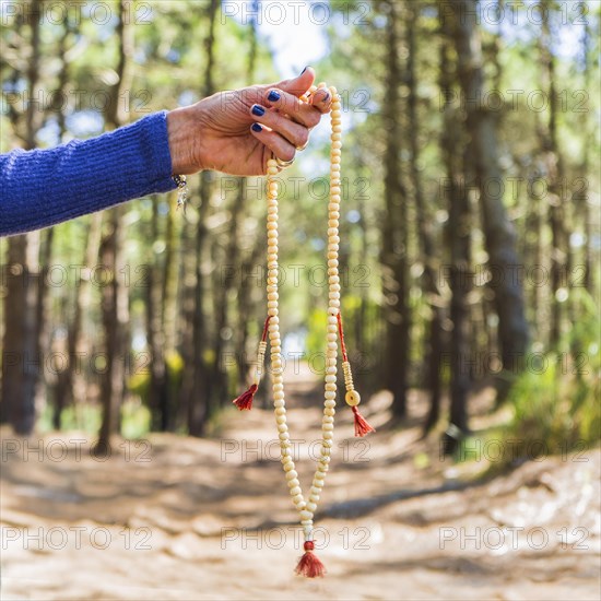 Close up of a japa mala over nature bakcground