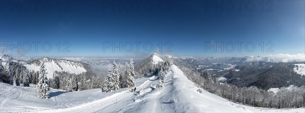 Winter landscape covered in deep snow in the Osterhorn group with a view from Pillstein to Zwoelferhorn and Wolfgangsee